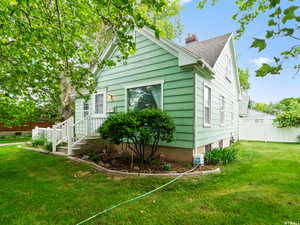 View of side of home featuring a yard