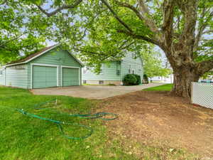 View of yard featuring a garage and an outdoor structure