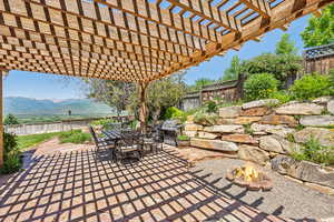 View of patio with a pergola and a mountain view