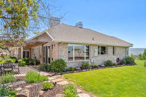 Rear view of property featuring a patio area and a yard