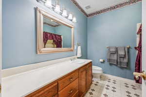 Bathroom with tile floors, vanity, and toilet