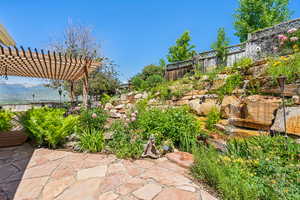 View of yard with a pergola, a patio, and a mountain view