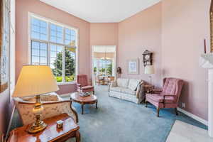 Living room featuring an inviting chandelier and carpet