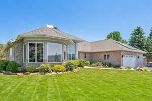 View of front of home featuring a garage and a front lawn