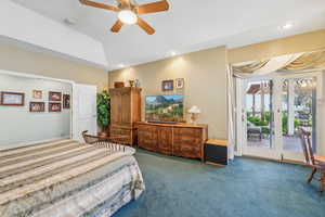 Bedroom featuring access to outside, carpet flooring, and ceiling fan