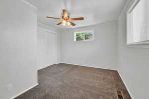 Bedroom featuring ceiling fan and crown molding