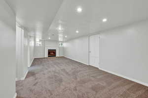 Basement living room with carpet flooring