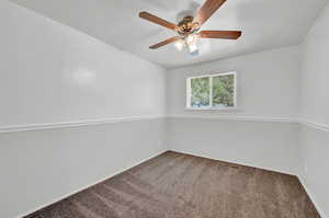 Bedroom with ceiling fan, carpet floors and ensuite bath