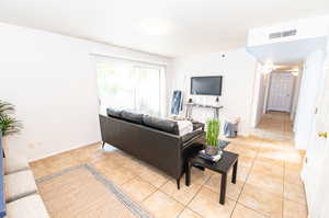 Living room featuring light tile flooring