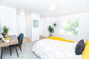 View of carpeted bedroom featuring two (2) closets and master bath