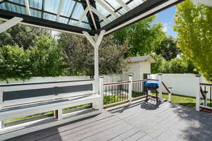 Wooden deck featuring area for grilling