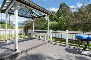 Wooden terrace with a playground and a gazebo