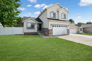 Front facade featuring a front lawn and a garage