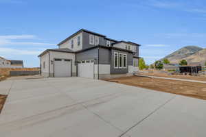 View of front facade with a garage and a mountain view