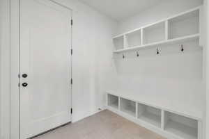 Mudroom with light tile patterned floors