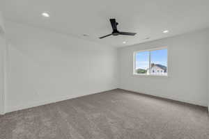 Unfurnished room with carpet floors and ceiling fan