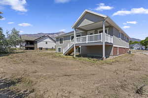 Back of property featuring a mountain view and central AC unit