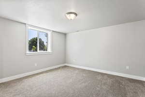 Unfurnished room with carpet flooring