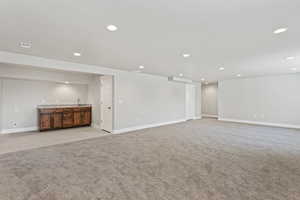 Unfurnished living room featuring light colored carpet