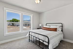 Carpeted bedroom featuring multiple windows