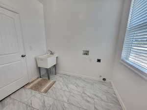 Laundry room featuring washer hookup, light tile flooring, and hookup for an electric dryer