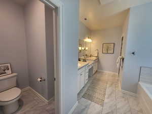 Bathroom with a bath to relax in, tile flooring, and double vanity