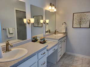 Bathroom featuring tile flooring and double vanity