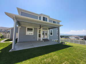 Back of house with a patio, ceiling fan, and a lawn