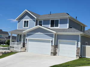 View of front of property with a garage and covered porch