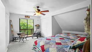 Carpeted bedroom with a closet, ceiling fan, and lofted ceiling