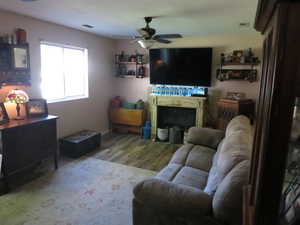 Family room with laminate flooring and ceiling fan