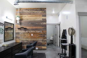 Home office with wooden walls and concrete flooring