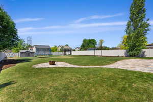 View of yard with an outdoor fire pit and a patio