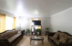 Living room featuring ornamental molding and hardwood / wood-style flooring