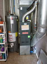 Utility room featuring water heater