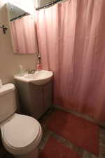 Bathroom with tile floors, oversized vanity, and toilet