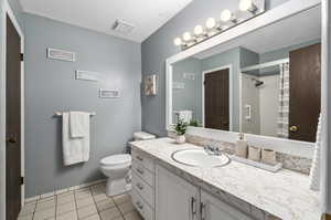 Bathroom with tile floors, toilet, and vanity