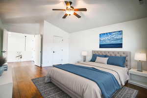 Bedroom with lofted ceiling, dark wood-type flooring, and ceiling fan