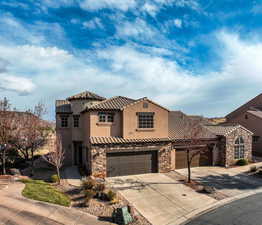 Mediterranean / spanish-style house with a garage