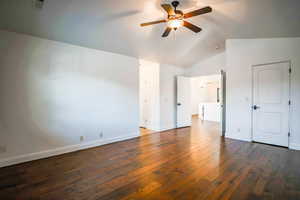 Interior space featuring vaulted ceiling, dark hardwood / wood-style floors, and ceiling fan