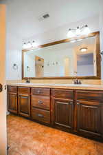 Bathroom featuring tile patterned flooring and vanity