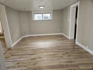 Unfurnished room featuring a textured ceiling and hardwood / wood-style floors