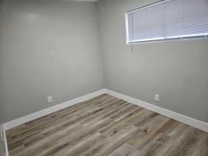 Spare room featuring wood-type flooring