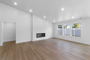 Unfurnished living room featuring light wood-type flooring