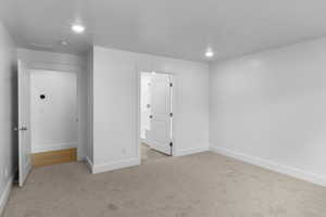 Unfurnished bedroom featuring light carpet