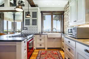 Kitchen featuring appliances with stainless steel finishes, hanging light fixtures, a healthy amount of sunlight, and sink