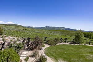 View of yard with a mountain view and a rural view