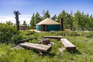 View of yard featuring a fire pit and an outdoor structure