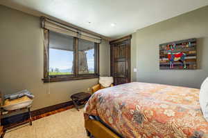 Bedroom with hardwood / wood-style flooring