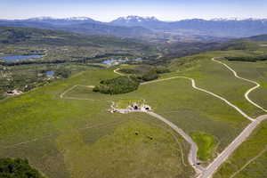 Birds eye view of property featuring a water and mountain view